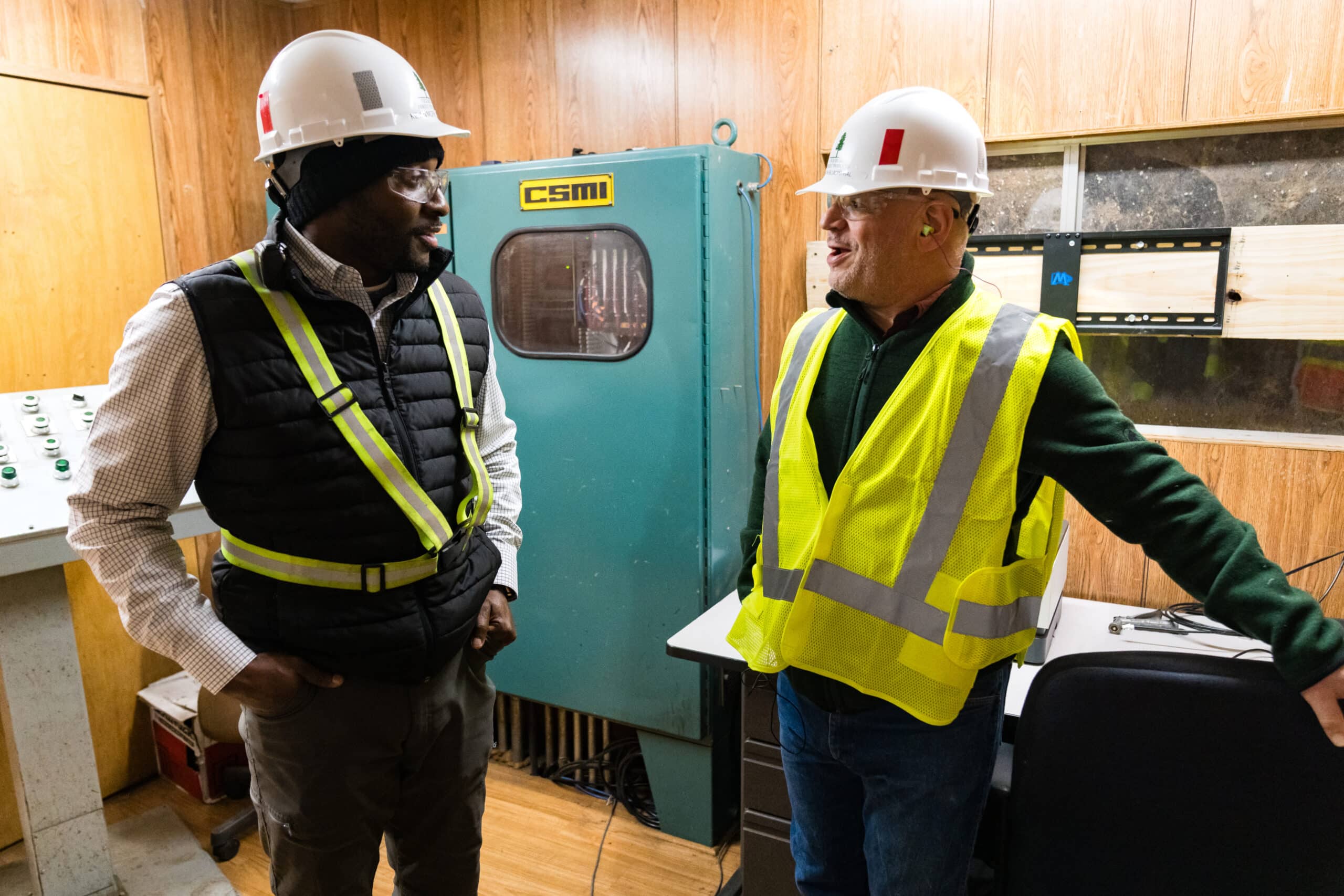 Two employees talking in control room