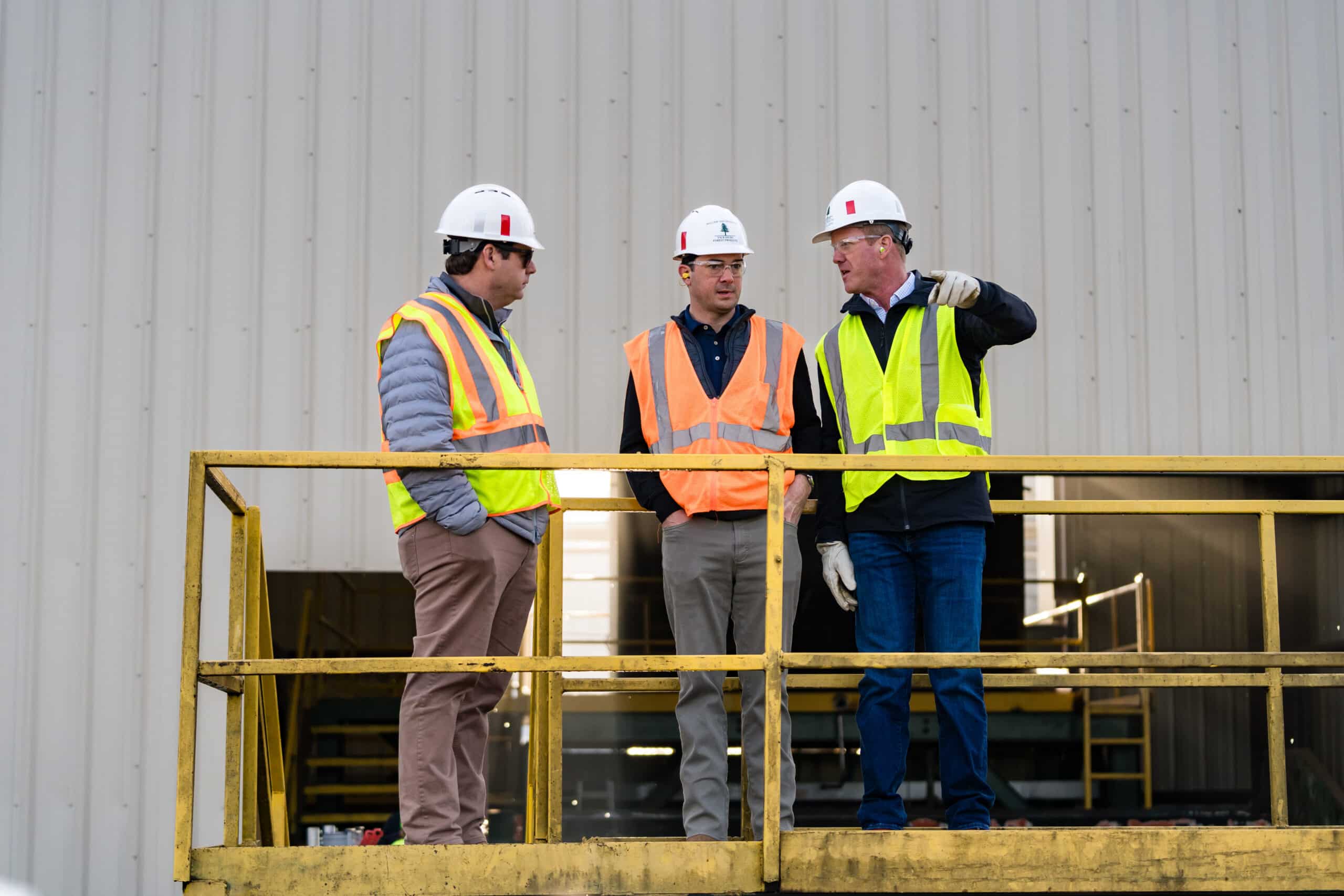 Three employees talking on platform